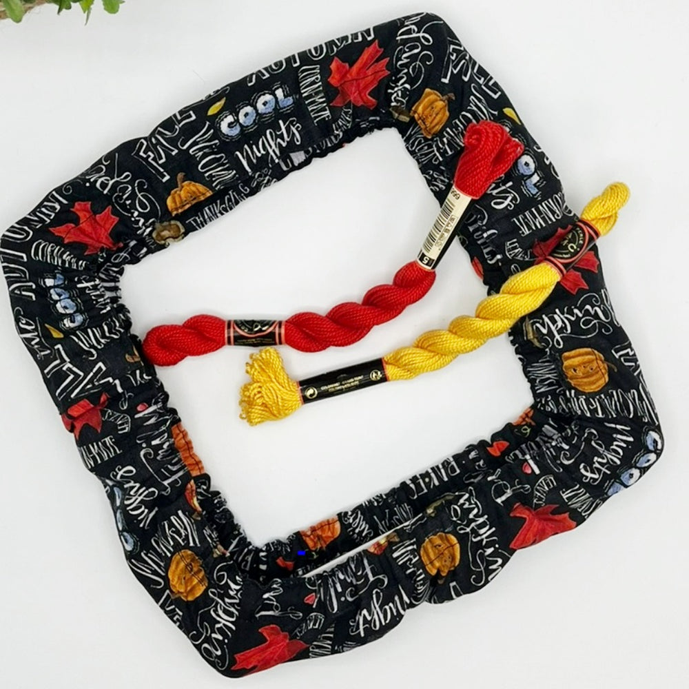 qsnap grime guard in fall theme fabric with harvest motive words on black background.