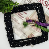 Black star-patterned qsnap embroidery frame with embroidery materials on a white background