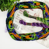 Colorful yarn ball with knitting needles and yarn on a white background