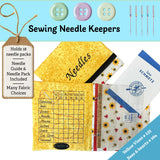 Sewing needle keepers with a yellow organizer, fabric choices, and sewing accessories on a blue background.