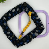 nurge frame grime guard in white and blue snowflakes on black background fabric.