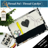 Thread catcher with sewing tools on a fabric background