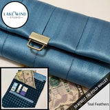 Blue seatbelt tri-fold wallet with gold buckle, Lake Wind Studio branding, and close-up of wallet on money.