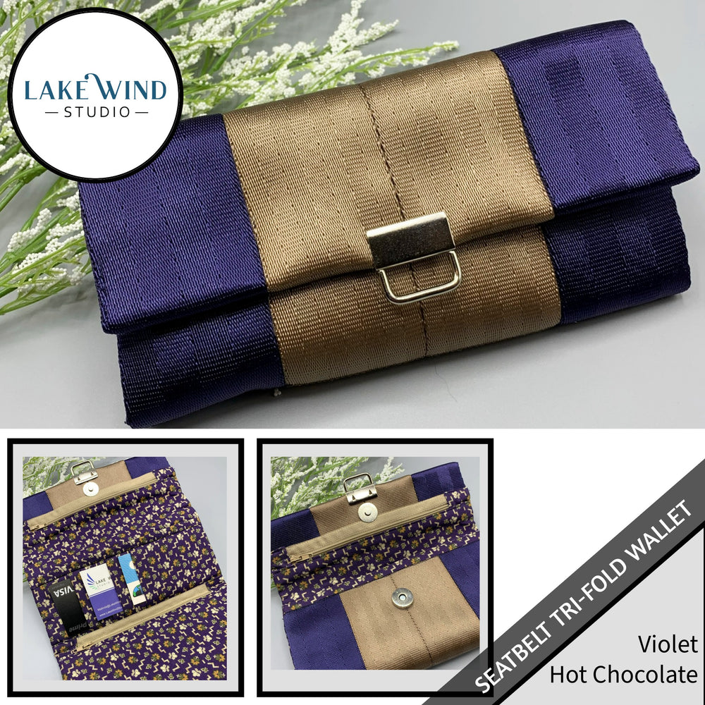 Tri-fold wallet with purple and brown design on a gray background, featuring Lake Wind Studio branding.