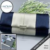 Navy and silver tri-fold wallet with a close-up inset on a gray background