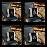 Black decorative throw pillows for Christmas with festive designs on a chair in front of a fireplace.