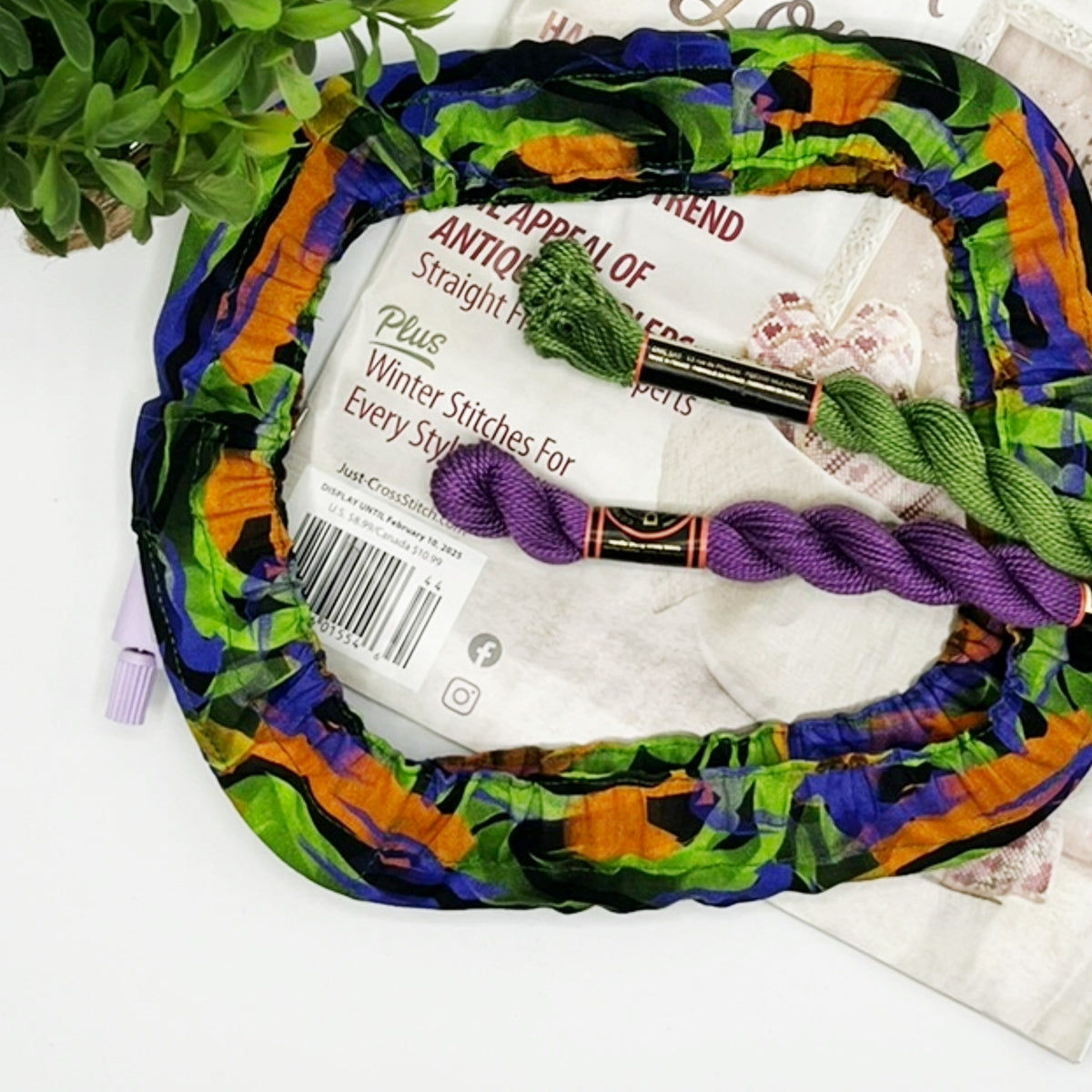 Colorful yarn ball with knitting needles and yarn on a white background
