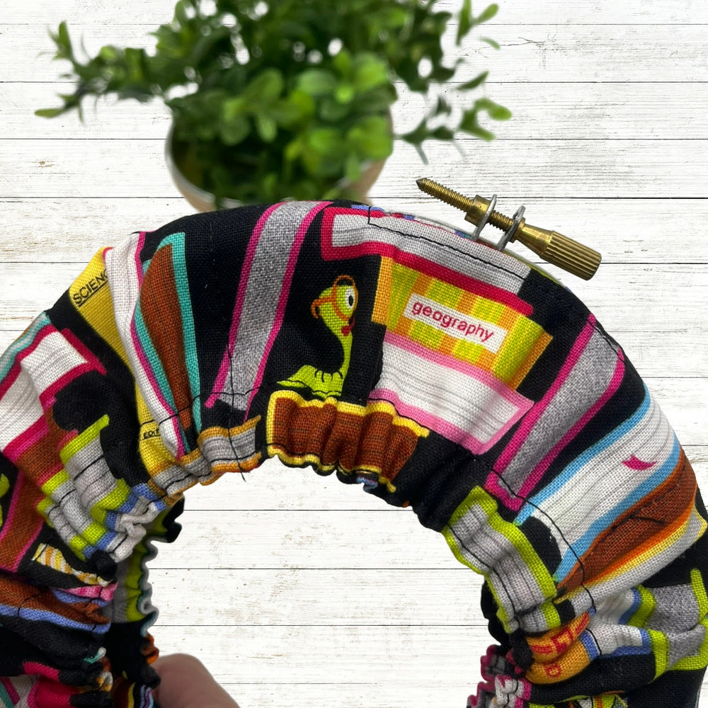 Colorful patterned with books and book worm in a hoop grime guard pattern