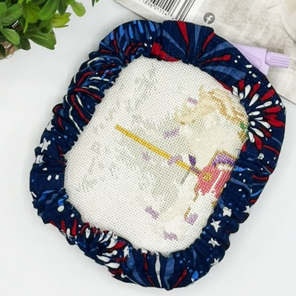 Decorative item with a cross-stitched design of a unicorn on a blue fabric border.