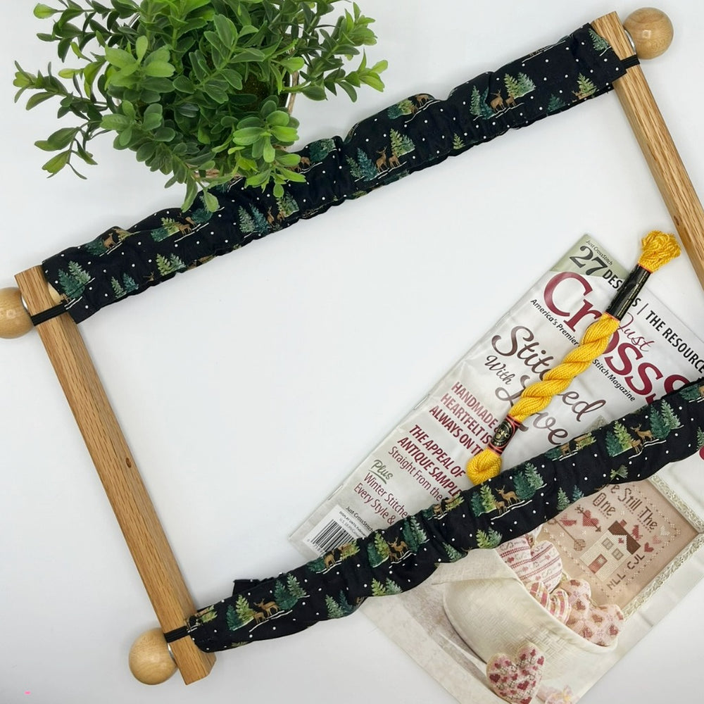 Scroll frame with winter theme grime guard with trees and deer. 