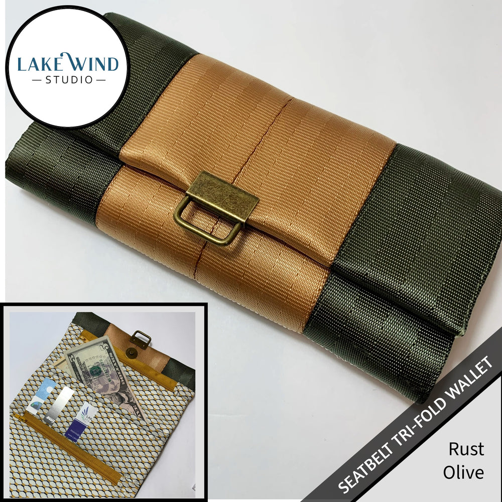 Tri-fold wallet in rust and olive green with 'Lake Wind Studio' branding.